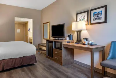 a hotel room with a bed and a desk with a television at Comfort Inn Horsham - Philadelphia in Horsham