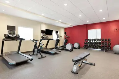 a gym with several treadmills and exercise bikes at Home2 Suites by Hilton New Brunswick, NJ in New Brunswick