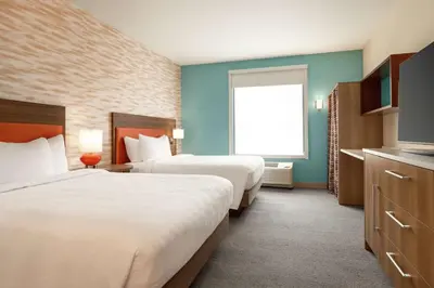 a hotel room with two beds and a window at Home2 Suites by Hilton New Brunswick, NJ in New Brunswick