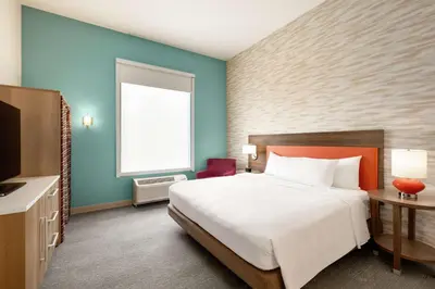 a hotel room with a bed and a television at Home2 Suites by Hilton New Brunswick, NJ in New Brunswick