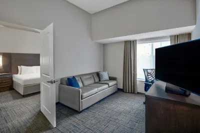 a living room with a couch and a flat screen tv at Residence Inn by Marriott Reading in Wyomissing