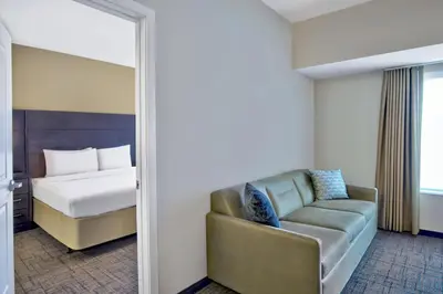 a room with a bed and a couch and a bedroom at Residence Inn by Marriott Reading in Wyomissing
