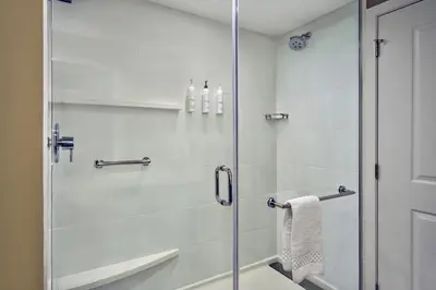 a glass shower door in a bathroom with a sink at Residence Inn by Marriott Reading in Wyomissing