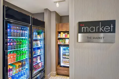 a store with a refrigerator and a market sign on a wall at Residence Inn by Marriott Reading in Wyomissing