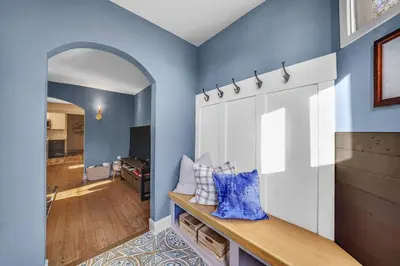 a room with blue walls and a wooden counter with pillows at Luxury Apartment in Historic Carriage House in Kennett Square