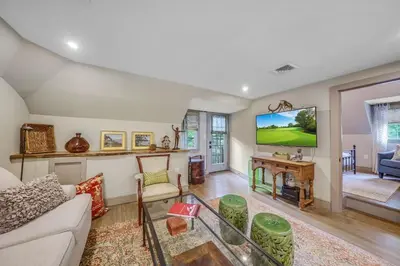 a living room with a couch and a tv at Luxury Loft in Historic Carriage House in Kennett Square