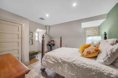 a bedroom with a large bed and a window at Luxury Loft in Historic Carriage House in Kennett Square