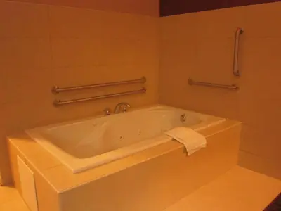 a bath tub in a bathroom with a sink at Red Carpet Inn and Suites Monmouth Junction in Monmouth Junction