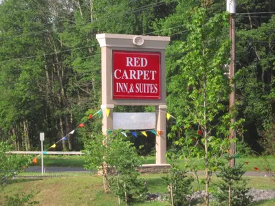 a red sign that reads red carpet inn and suites at Red Carpet Inn and Suites Monmouth Junction in Monmouth Junction