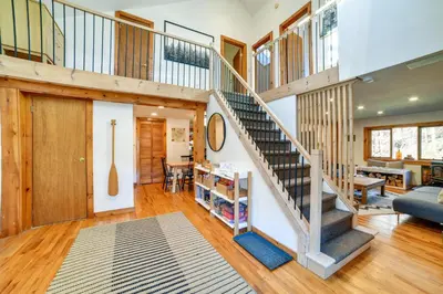 a staircase in a house with a living room at Hilltop Walton Getaway with Picturesque Views! in Walton
