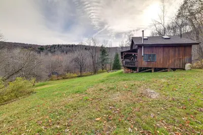 a wooden cabin on a hill in a field at Hilltop Walton Getaway with Picturesque Views! in Walton