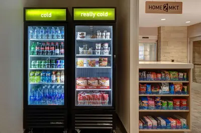 a large refrigerator filled with lots of drinks in a store at Home2 Suites East Hanover, NJ in East Hanover