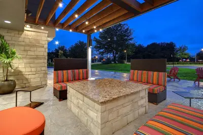 a patio with two chairs and a table at Home2 Suites East Hanover, NJ in East Hanover