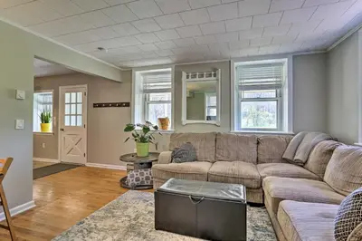 a living room with a couch and a table at Patio and Fire Pit Idyllic Cottage in Hellertown! in Bethlehem