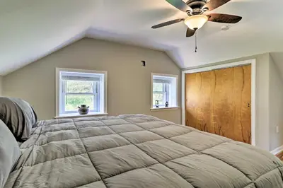 a bedroom with a bed and a ceiling fan at Patio and Fire Pit Idyllic Cottage in Hellertown! in Bethlehem