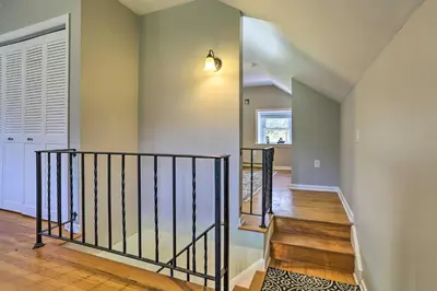 a staircase in a house with a stair case at Patio and Fire Pit Idyllic Cottage in Hellertown! in Bethlehem
