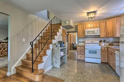 a kitchen with a spiral staircase in a house at Patio and Fire Pit Idyllic Cottage in Hellertown! in Bethlehem