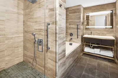 a bathroom with a shower and a sink at Hilton Club The Central at 5th New York in New York