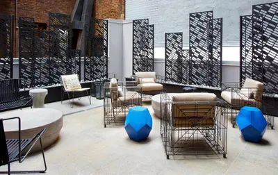 a lobby with chairs and tables in a building at Hilton Club The Central at 5th New York in New York