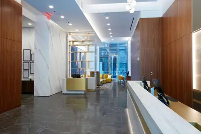 an office lobby with a view of the city at Hilton Club The Central at 5th New York in New York