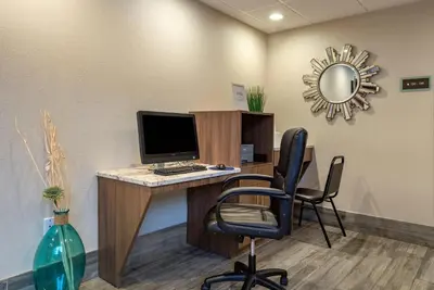 an office with a desk with a computer and chairs at MainStay Suites Horsham - Philadelphia in Horsham