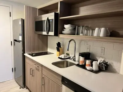 a kitchen with a sink and a refrigerator at MainStay Suites Horsham - Philadelphia in Horsham