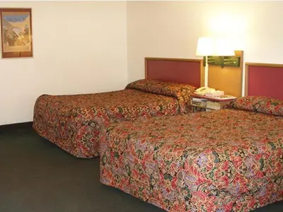 a hotel room with two beds and a telephone at Knights Inn Center Valley in Center Valley