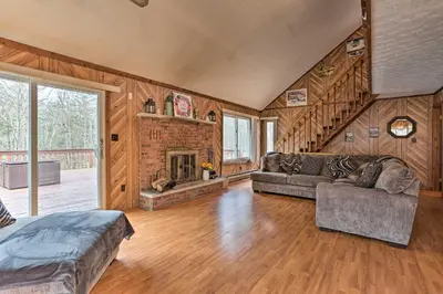 a living room with a couch and a fireplace at Resort Perks Picturesque Poconos Getaway! in Bushkill