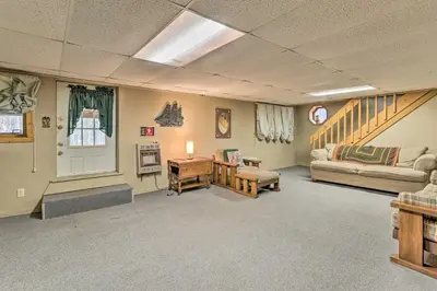 a living room with a couch and a table at Resort Perks Picturesque Poconos Getaway! in Bushkill