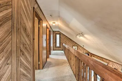 a hallway with wood paneled walls and a staircase at Resort Perks Picturesque Poconos Getaway! in Bushkill