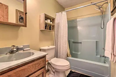 a bathroom with a toilet and a sink and a shower at Resort Perks Picturesque Poconos Getaway! in Bushkill