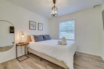 a bedroom with a bed and a mirror at 7 Mi to Camelback Mtn Chic Penn Estates Home in East Stroudsburg