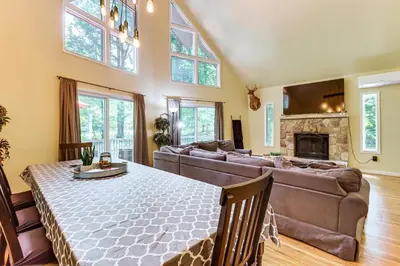 a large living room with a couch and a fireplace at Furnished Deck and Fire Pit Poconos Outdoorsy Gem in Albrightsville