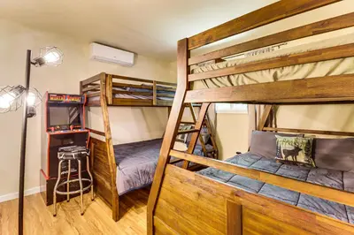 two bunk beds in a room with a ladder at Furnished Deck and Fire Pit Poconos Outdoorsy Gem in Albrightsville