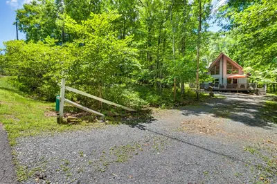 a house with a fence in front of it at Furnished Deck and Fire Pit Poconos Outdoorsy Gem in Albrightsville