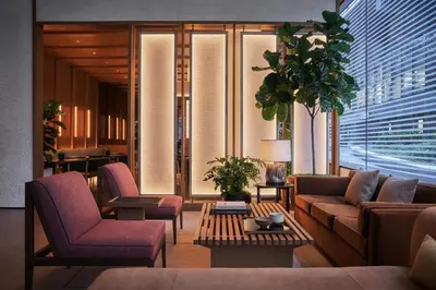 a lobby with couches and chairs and a table at Pendry Manhattan West in New York