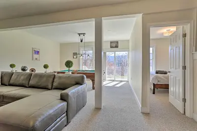 a living room with a couch and a pool table at New ! Slopeside Townhome : WFH, Ski, Dine & Hike in Tannersville