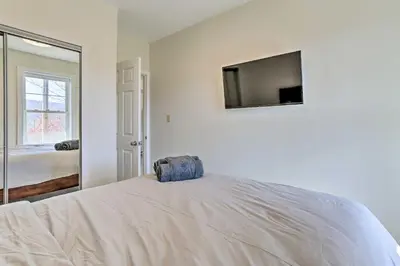 a bedroom with a bed with a television on the wall at New ! Slopeside Townhome : WFH, Ski, Dine & Hike in Tannersville