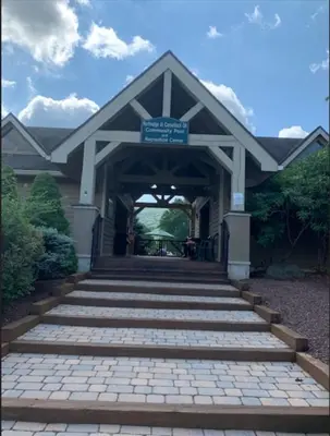 a building with a bridge with a sign on it at New ! Slopeside Townhome : WFH, Ski, Dine & Hike in Tannersville