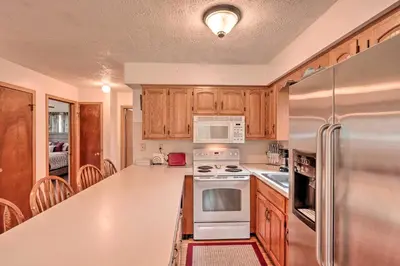 a kitchen with wooden cabinets and stainless steel appliances at 7 Mi to Big Boulder Mountain Poconos Escape! in Albrightsville