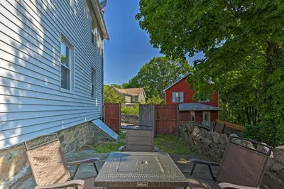 a patio with a table and chairs next to a house at Updated Home with Patio Half Mile to West Point in Highland Falls
