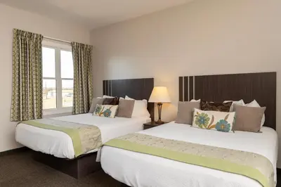 a hotel room with two beds and a window at Brinton Suites in West Chester