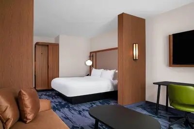 a hotel room with a bed and a couch at Fairfield by Marriott Inn & Suites Lebanon Near Expo Center in Lebanon