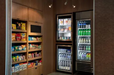 a kitchen with two refrigerators with drinks and soda at Fairfield by Marriott Inn & Suites Lebanon Near Expo Center in Lebanon
