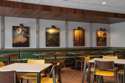 a dining room with tables and yellow chairs at Fairfield by Marriott Inn & Suites Lebanon Near Expo Center in Lebanon