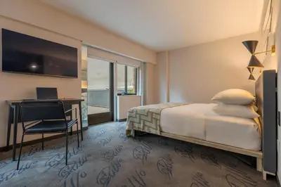 a hotel room with a bed and a desk at Pestana CR7 Times Square in New York