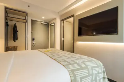 a bedroom with a bed and a flat screen tv at Pestana CR7 Times Square in New York