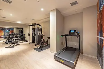 a gym with treadmills and weights in a room at Pestana CR7 Times Square in New York