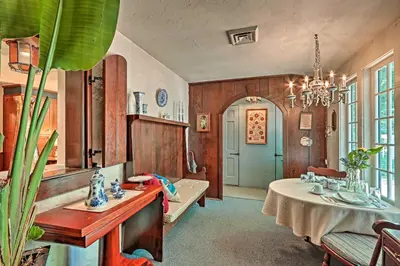 a living room with a table and a chandelier at Pool and Courtyard Timeless Home in Lansdale in Lansdale