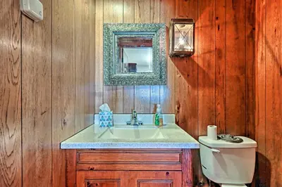 a bathroom with a sink and a toilet and a mirror at Pool and Courtyard Timeless Home in Lansdale in Lansdale